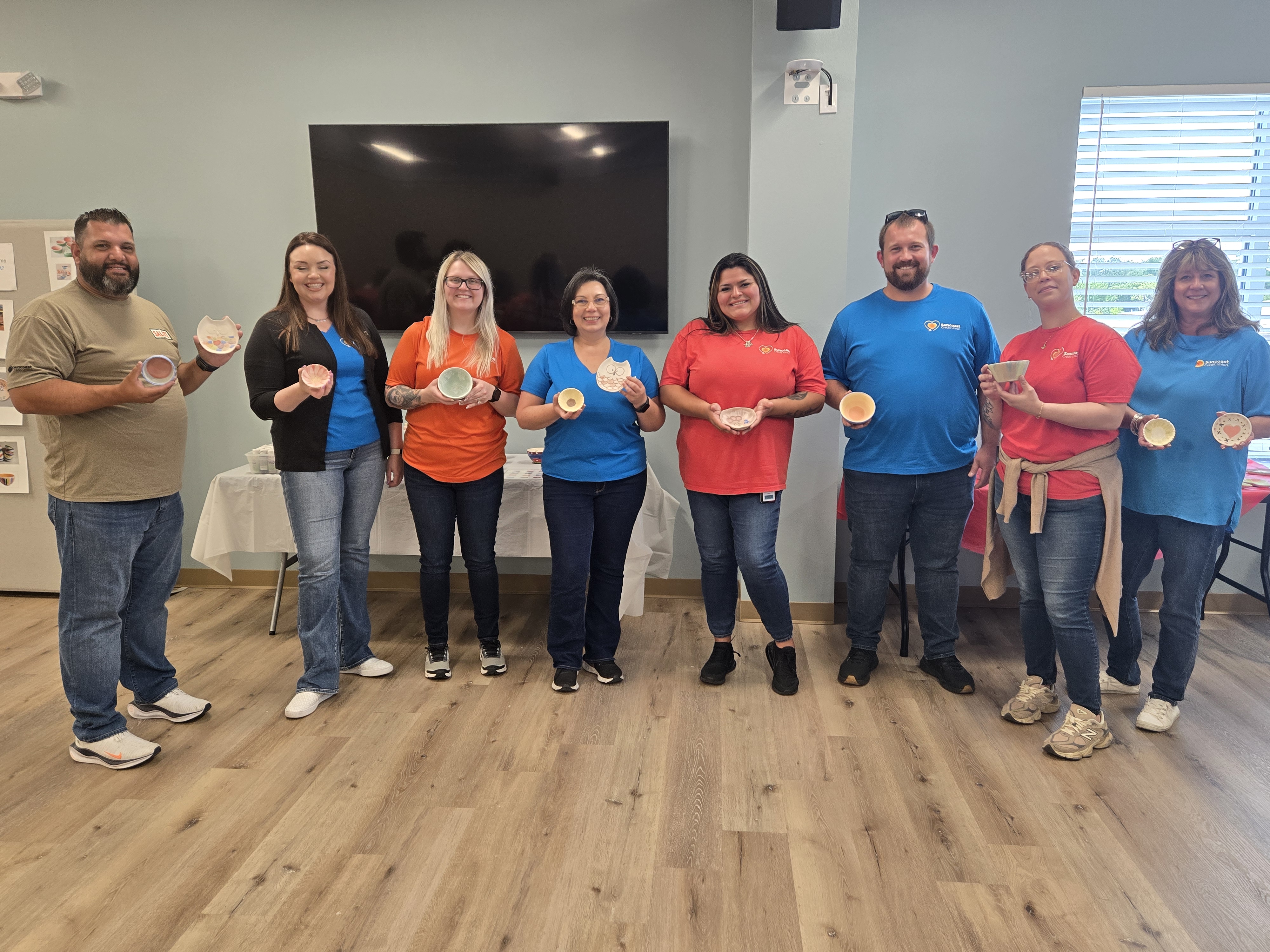 Volunteers painting ceramic bowls for the Empty Bowls charity fundraiser